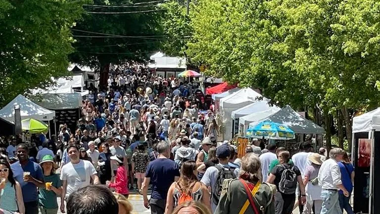 Crowds at the Inman Park Festival on the tree-lined streets of the neighborhood