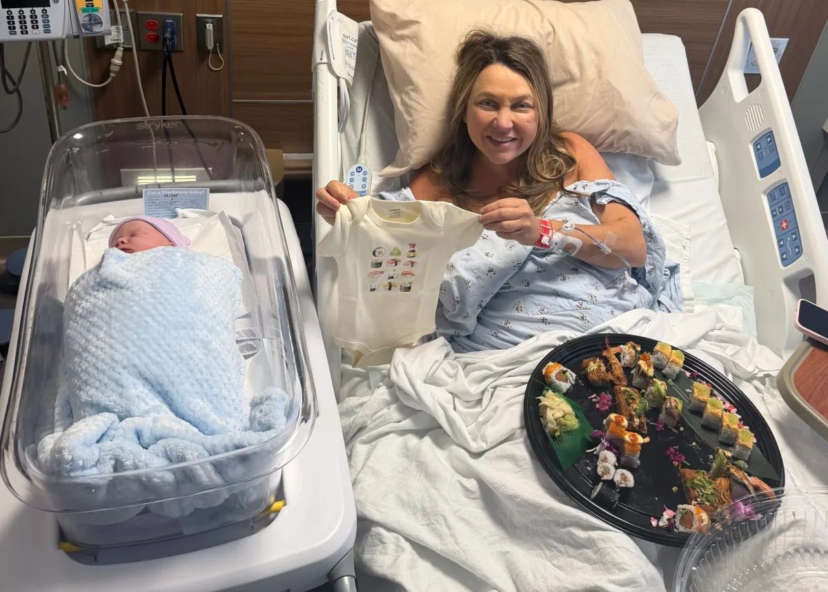 A new mom with a sushi platter delivered by Nakato Japanese Restaurant