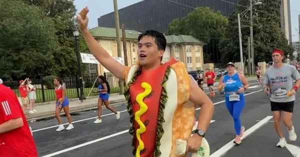 A runner dressed as a hot dog during the Peachtree Road Race