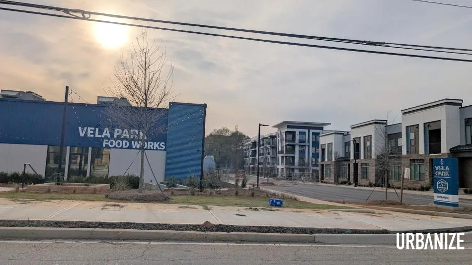 Interior rendering of Vela Park Food Works showing multiple vendor stalls